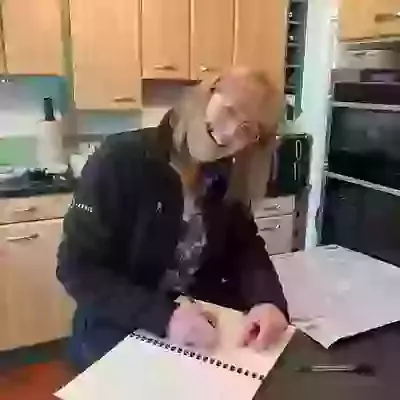 Eileen signing the contract.